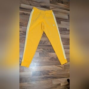 Adidas Adults Size Medium Colligate Golden Joggers with White Stripes